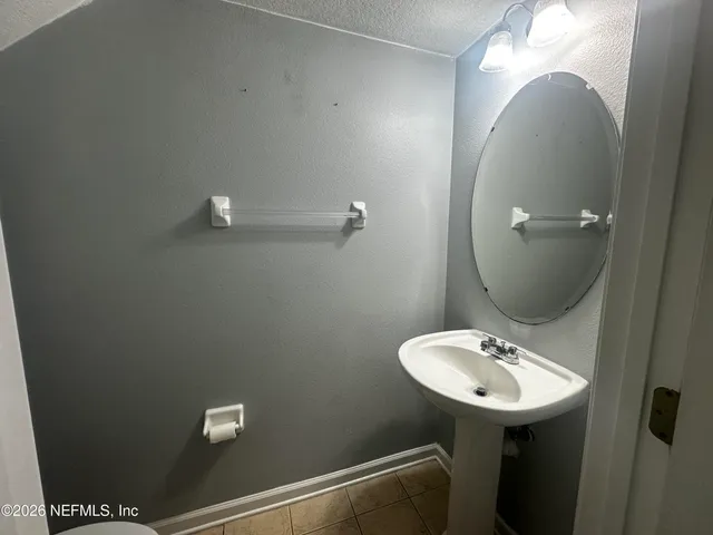 a bathroom with a sink and mirror