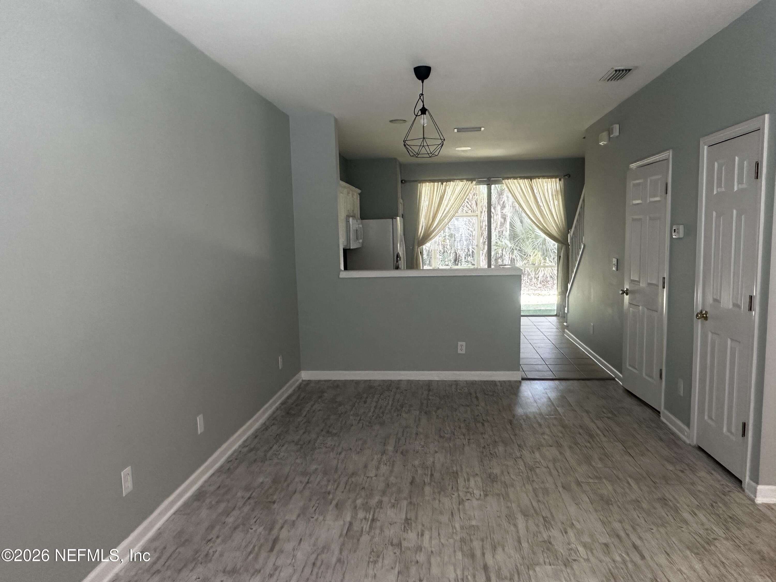 3548 Lone Tree Lane Jacksonville, FL 32216 - Photo 6 of 10 an empty room with a empty space and windows