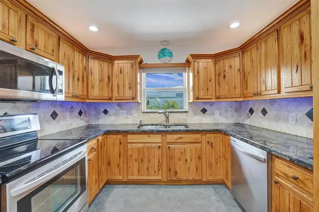 a kitchen with sink cabinets and window