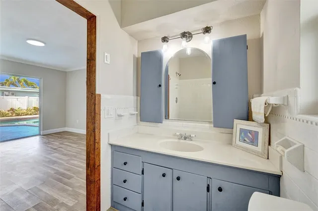 a bathroom with a sink vanity and a mirror
