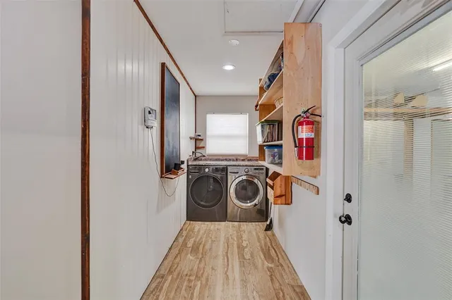 a view of a hallway with a washer and dryer