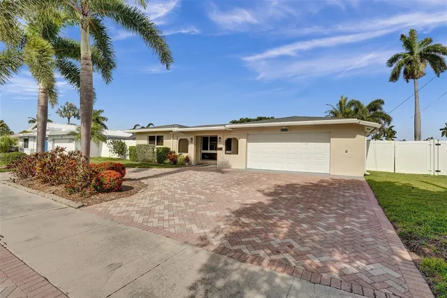 a view of a house with a yard and potted plants
