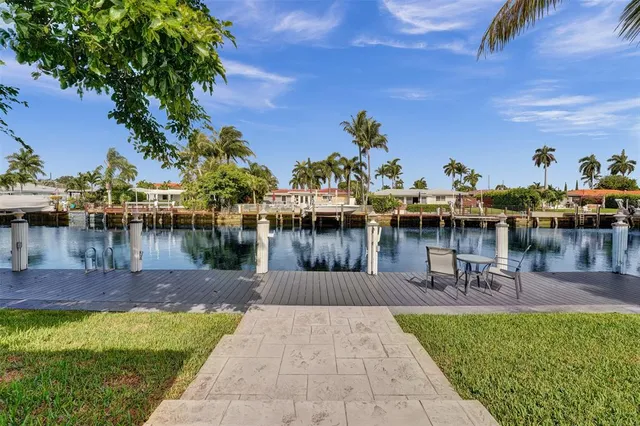 a swimming pool with outdoor seating and lake view