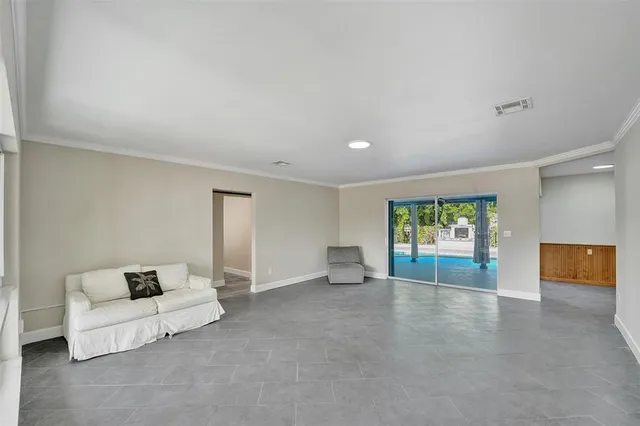 an empty room with furniture and window