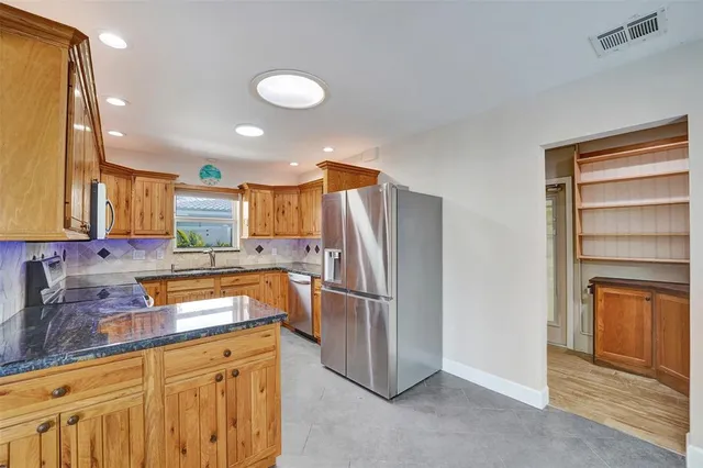 a kitchen with a refrigerator and a sink