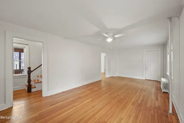 a view of an empty room and wooden floor