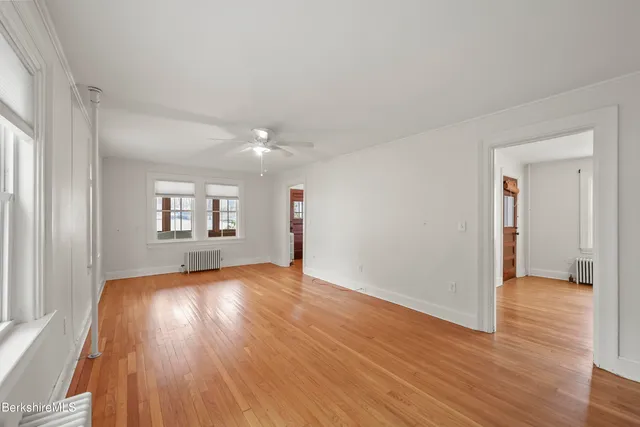 wooden floor in an empty room with a window
