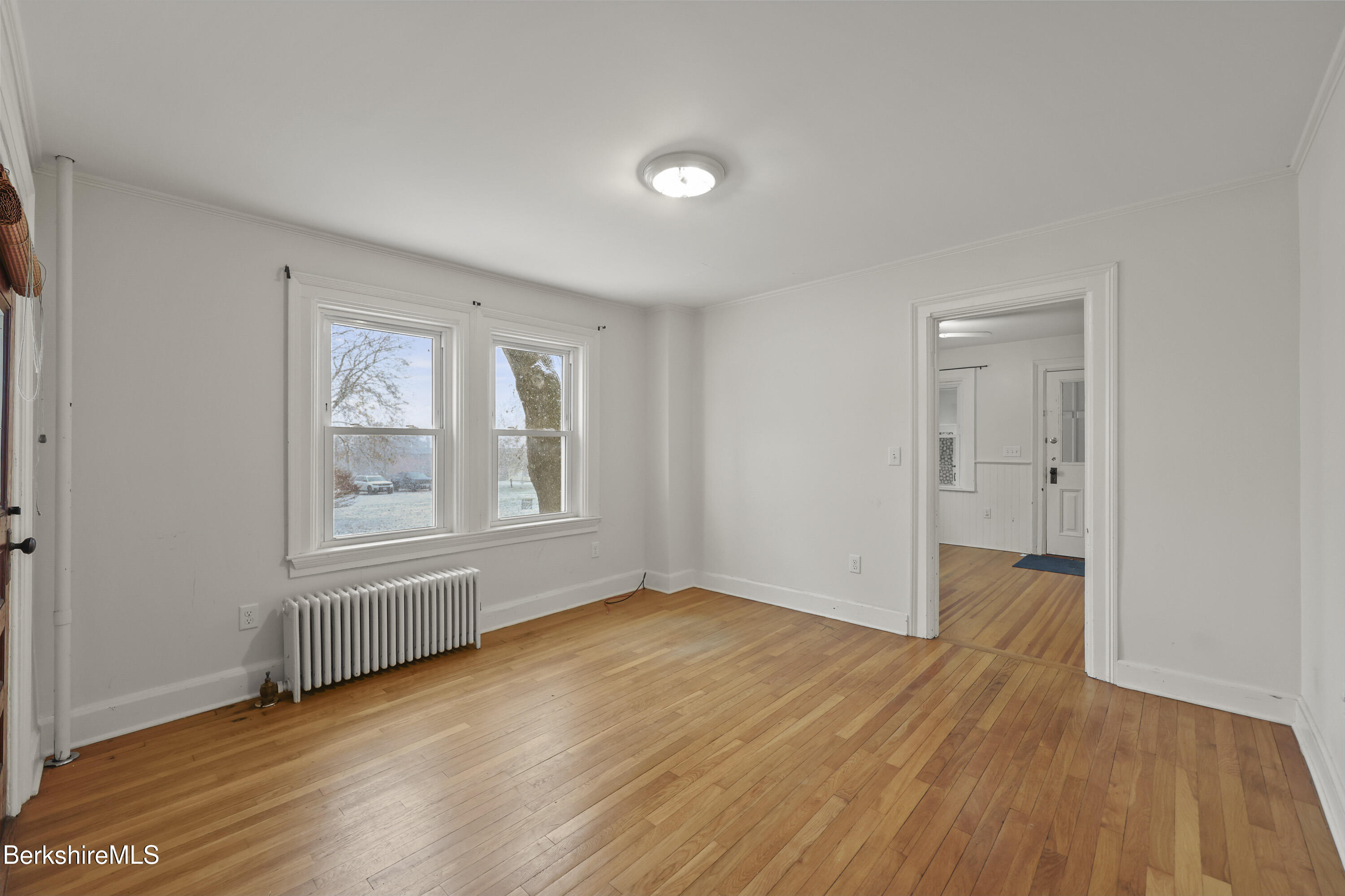 155 Laurel Street Lee, MA 01238 - Photo 14 of 43 an empty room with wooden floor and windows