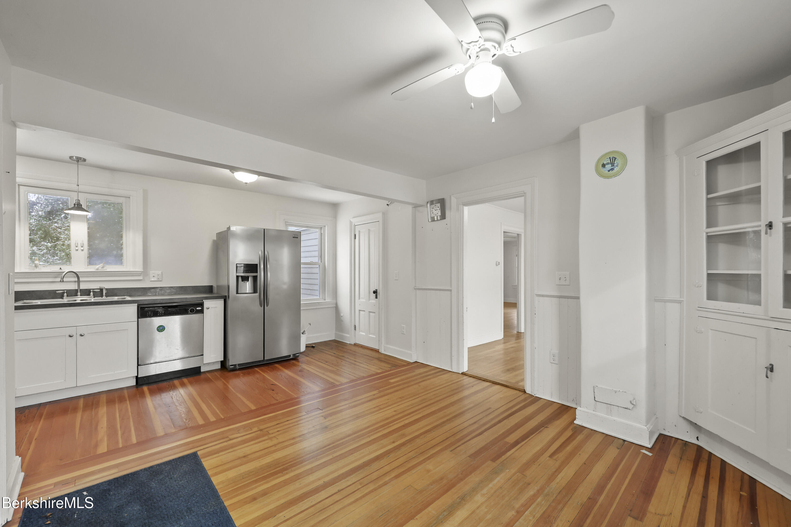 155 Laurel Street Lee, MA 01238 - Photo 20 of 43 a large white kitchen with granite countertop a refrigerator and microwave