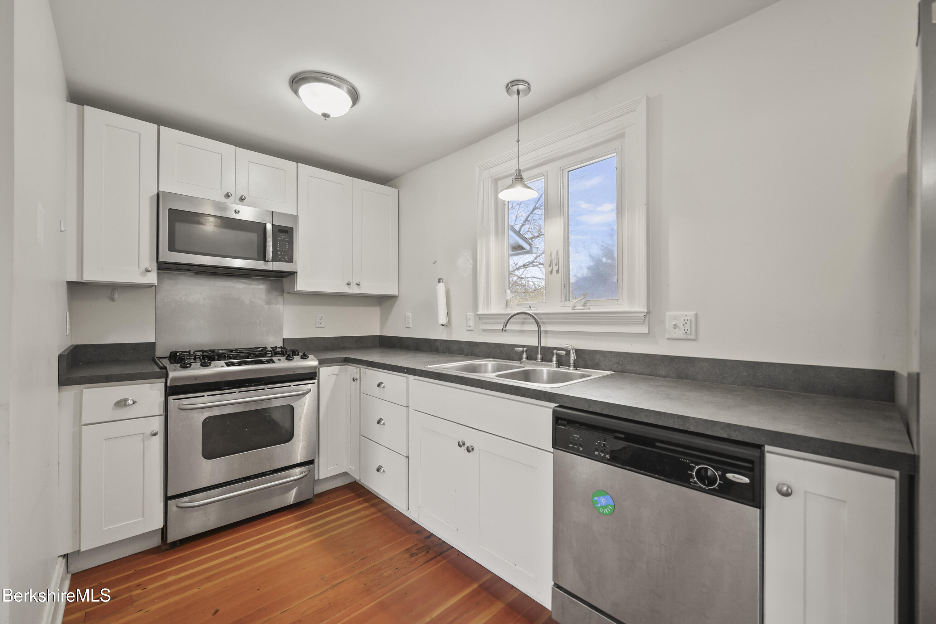 155 Laurel Street Lee, MA 01238 - Photo 22 of 43 a kitchen with stainless steel appliances granite countertop a stove a sink and a microwave