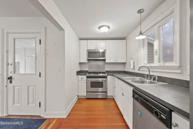 a kitchen with a sink stove and cabinets
