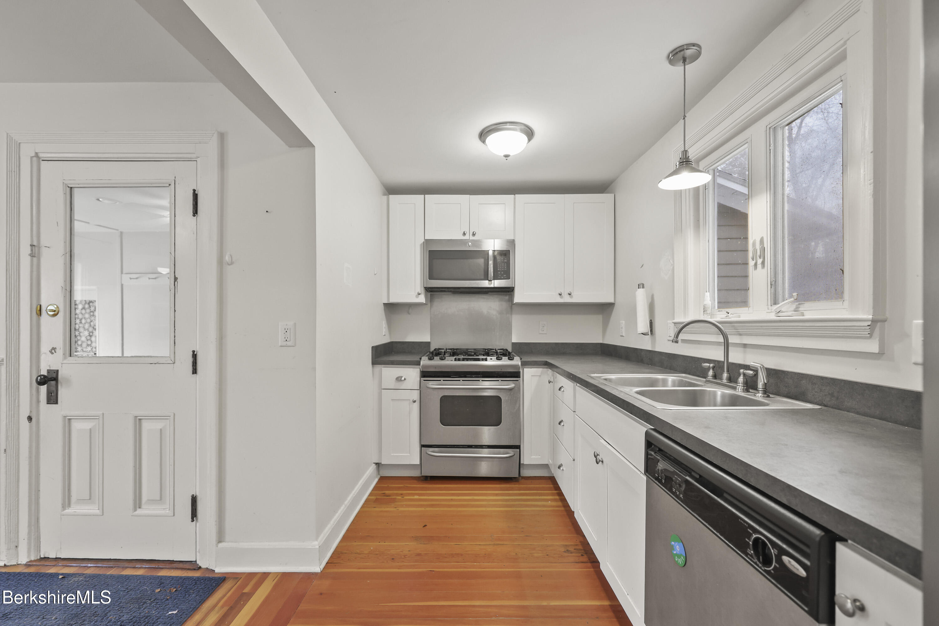 155 Laurel Street Lee, MA 01238 - Photo 23 of 43 a kitchen with a sink stove and cabinets