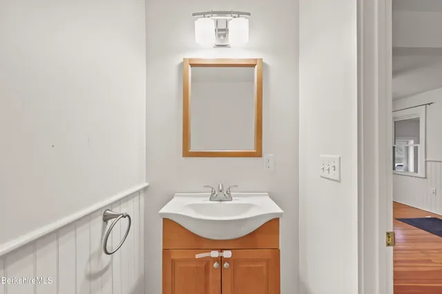 a bathroom with a sink vanity and a mirror