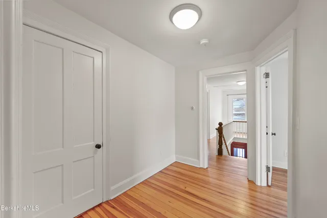 a view of a room with wooden floor