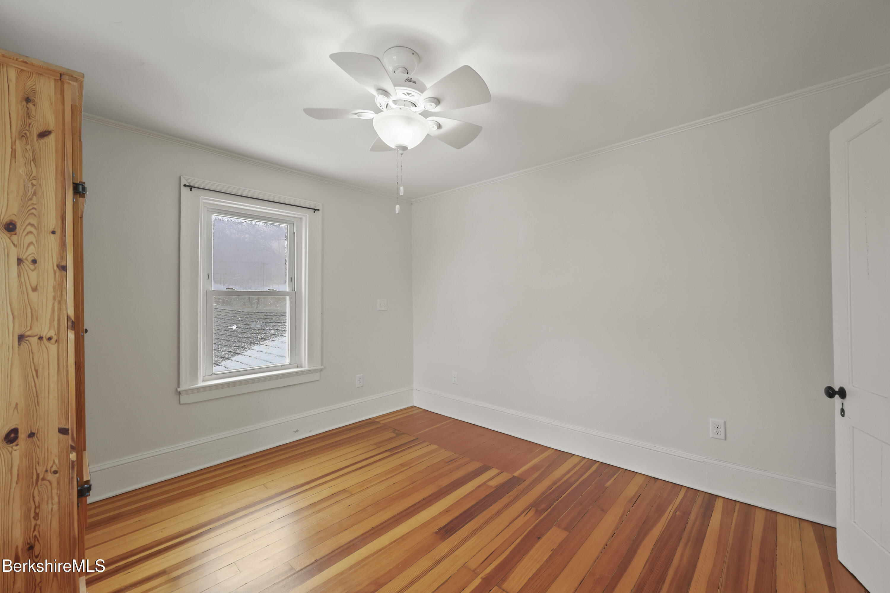 155 Laurel Street Lee, MA 01238 - Photo 36 of 43 a view of an empty room with wooden floor and a window