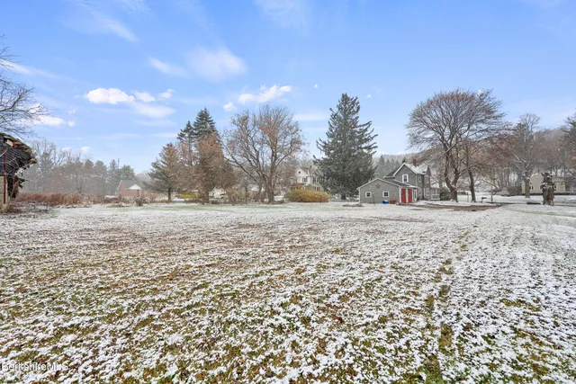 a view of dirt field with trees