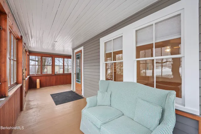 a living room with furniture and large windows