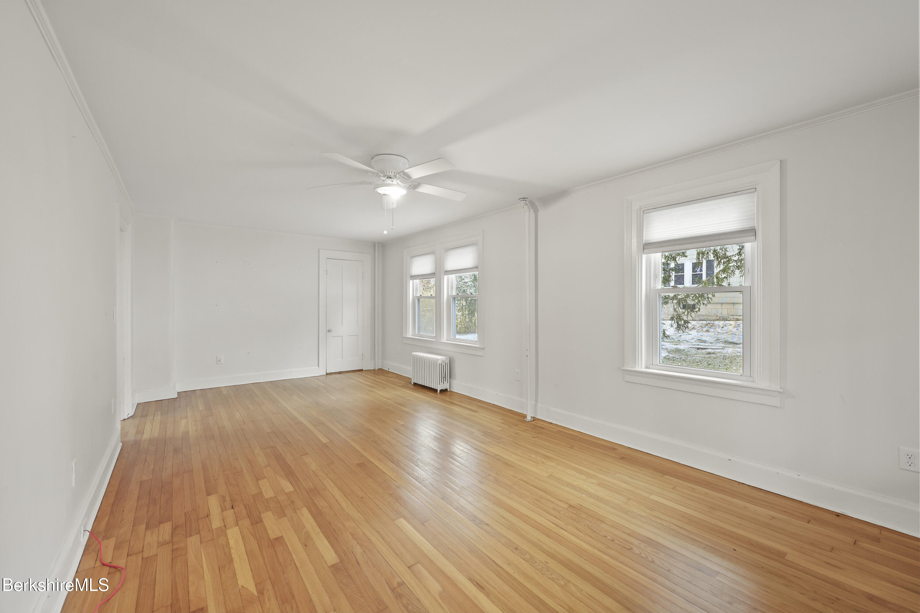 155 Laurel Street Lee, MA 01238 - Photo 10 of 43 an empty room with wooden floor and windows