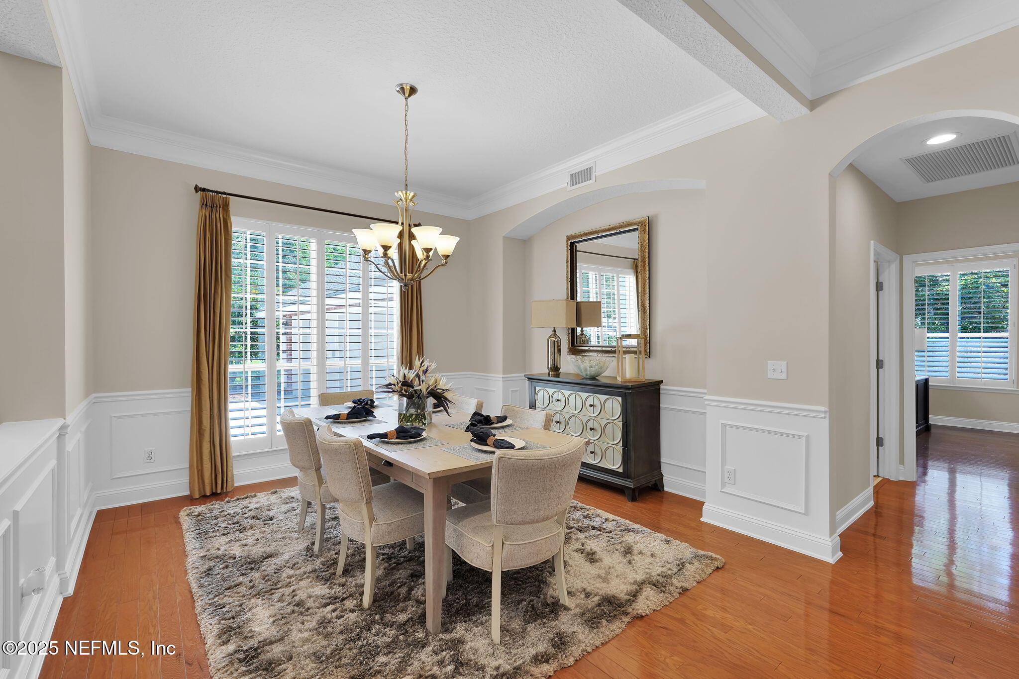 219 Parkside Drive St. Augustine, FL 32095 - Photo 9 of 67 a dining room with wooden floor a chandelier a wooden table and chairs
