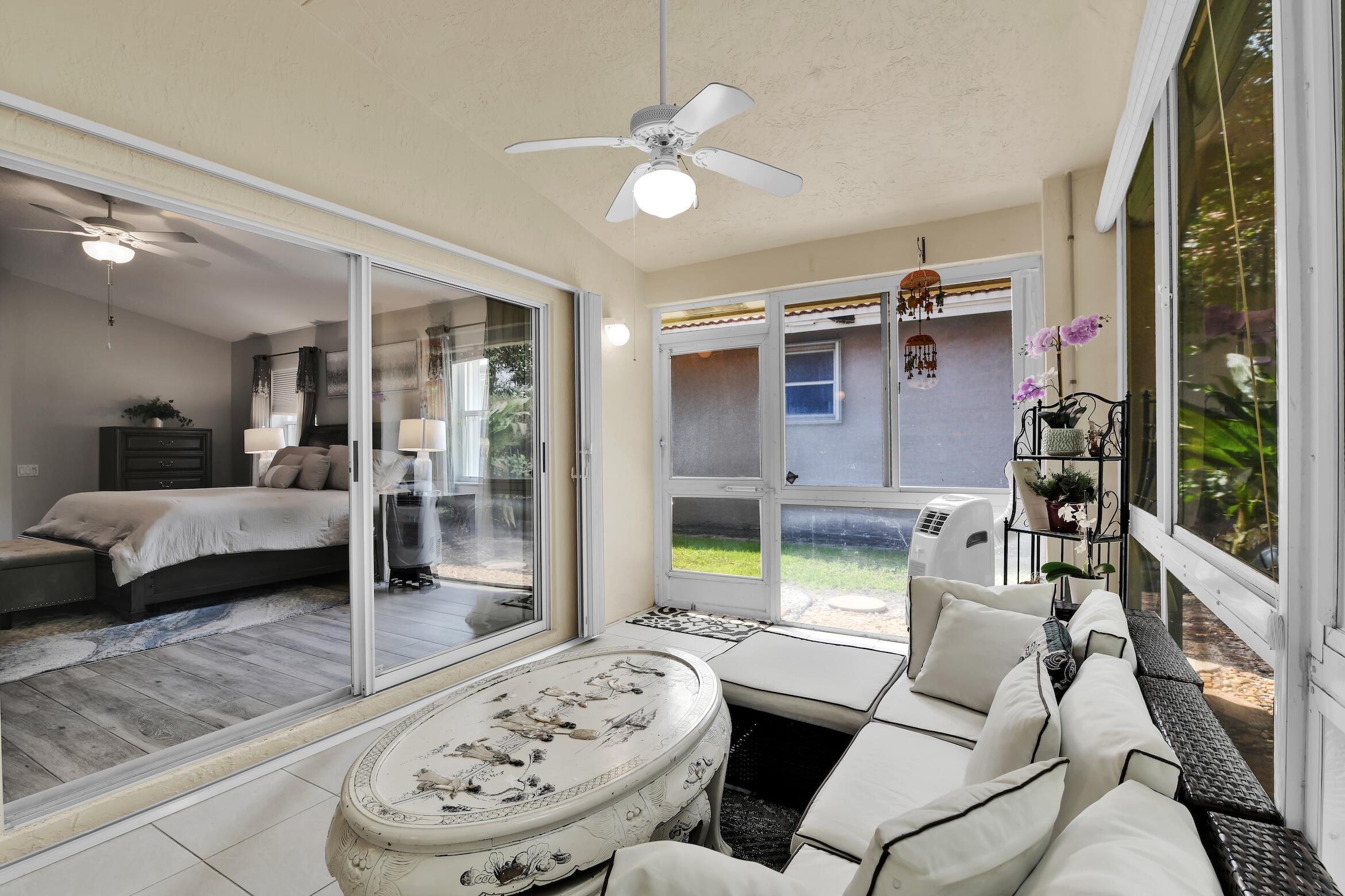 7458 Falls Road West Boynton Beach, FL 33437 - Photo 17 of 45 a living room with furniture and a large window