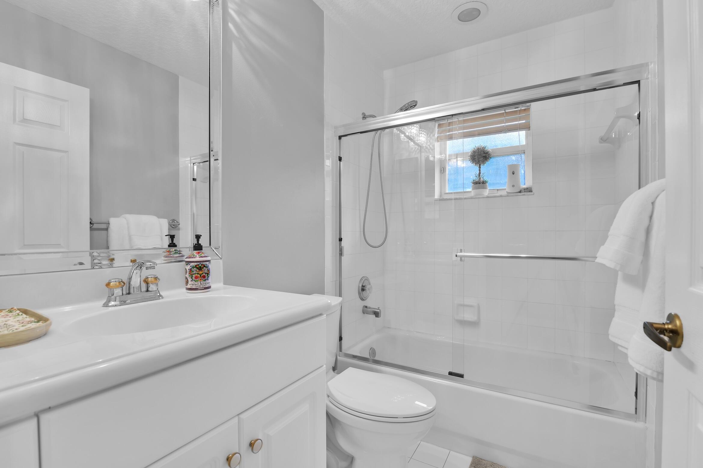 7458 Falls Road West Boynton Beach, FL 33437 - Photo 28 of 45 a bathroom with a sink toilet and shower