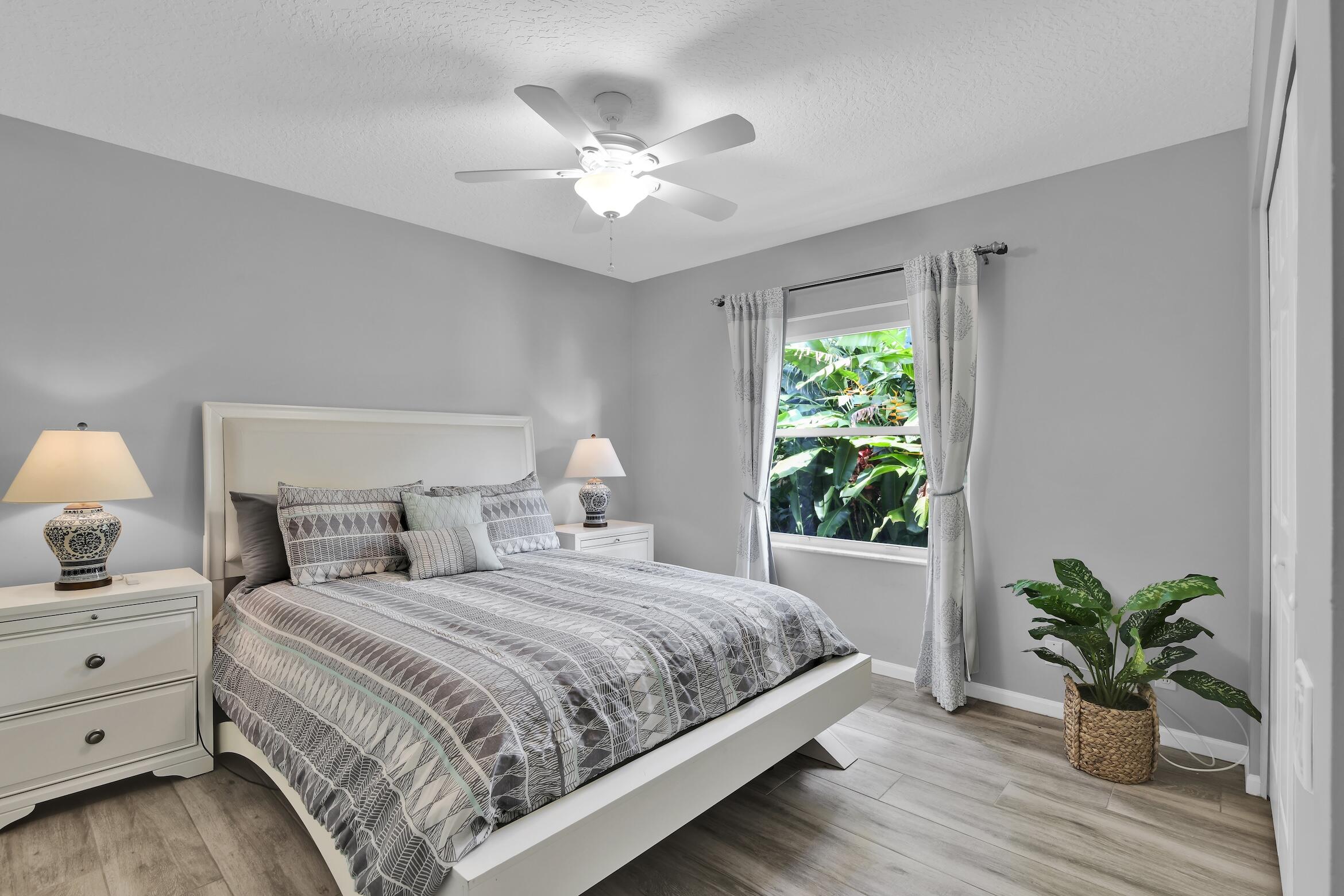 7458 Falls Road West Boynton Beach, FL 33437 - Photo 29 of 45 a bedroom with double bed and a potted plant