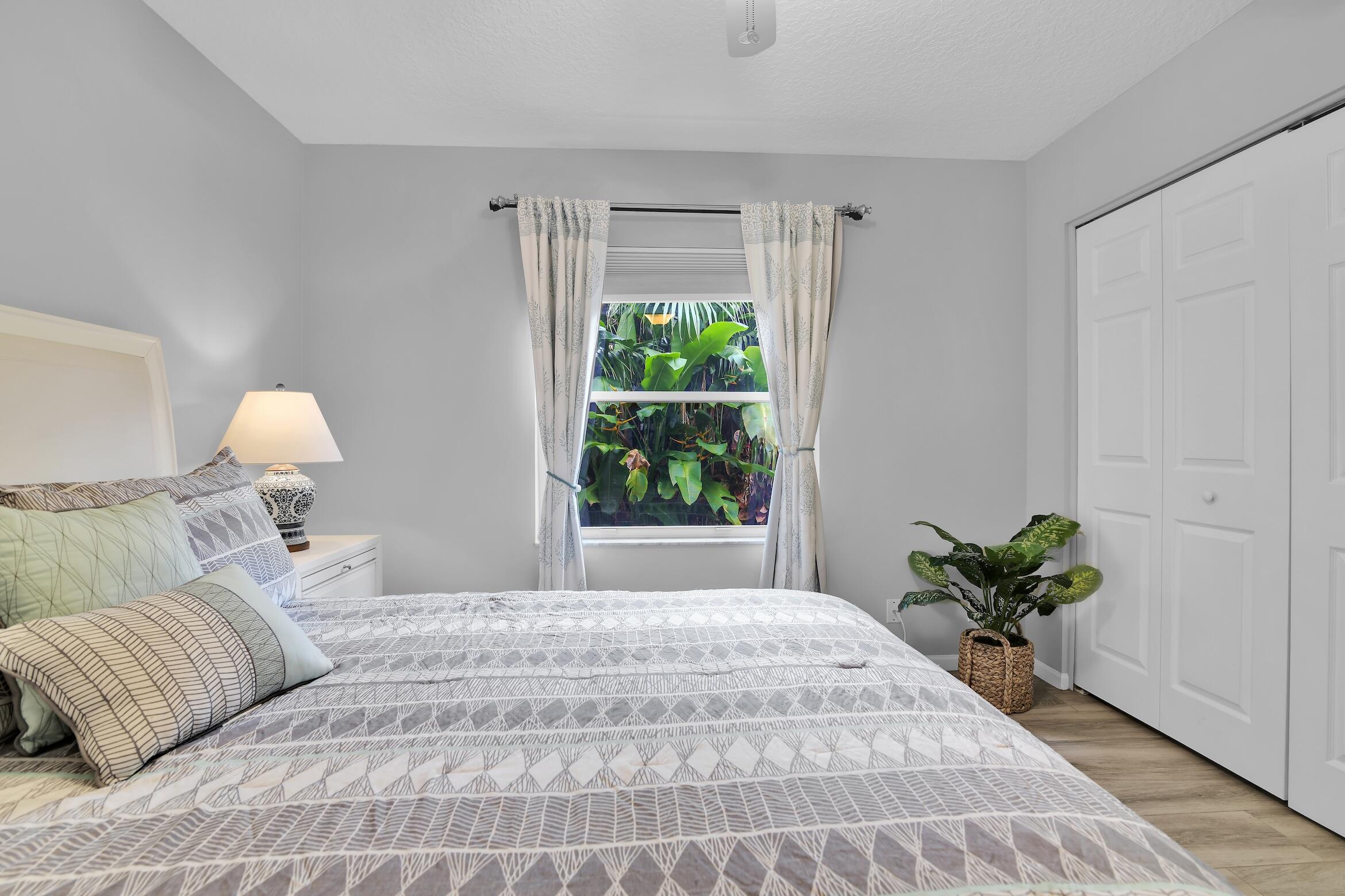 7458 Falls Road West Boynton Beach, FL 33437 - Photo 30 of 45 a bedroom with a bed mirror and window