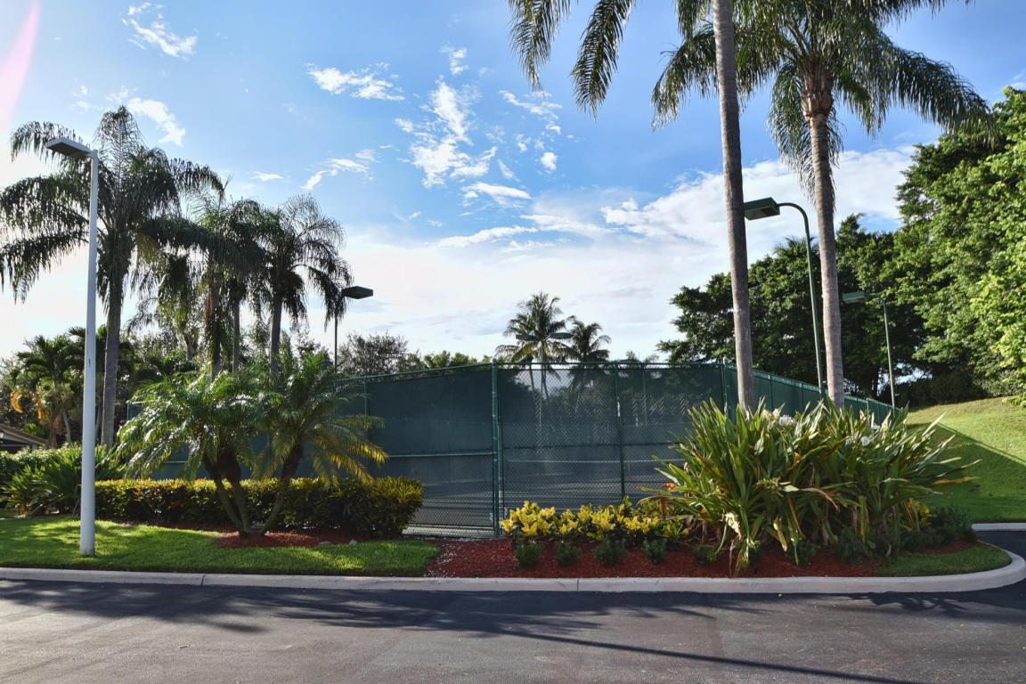 7458 Falls Road West Boynton Beach, FL 33437 - Photo 45 of 45 front view of a house with a garden and a yard