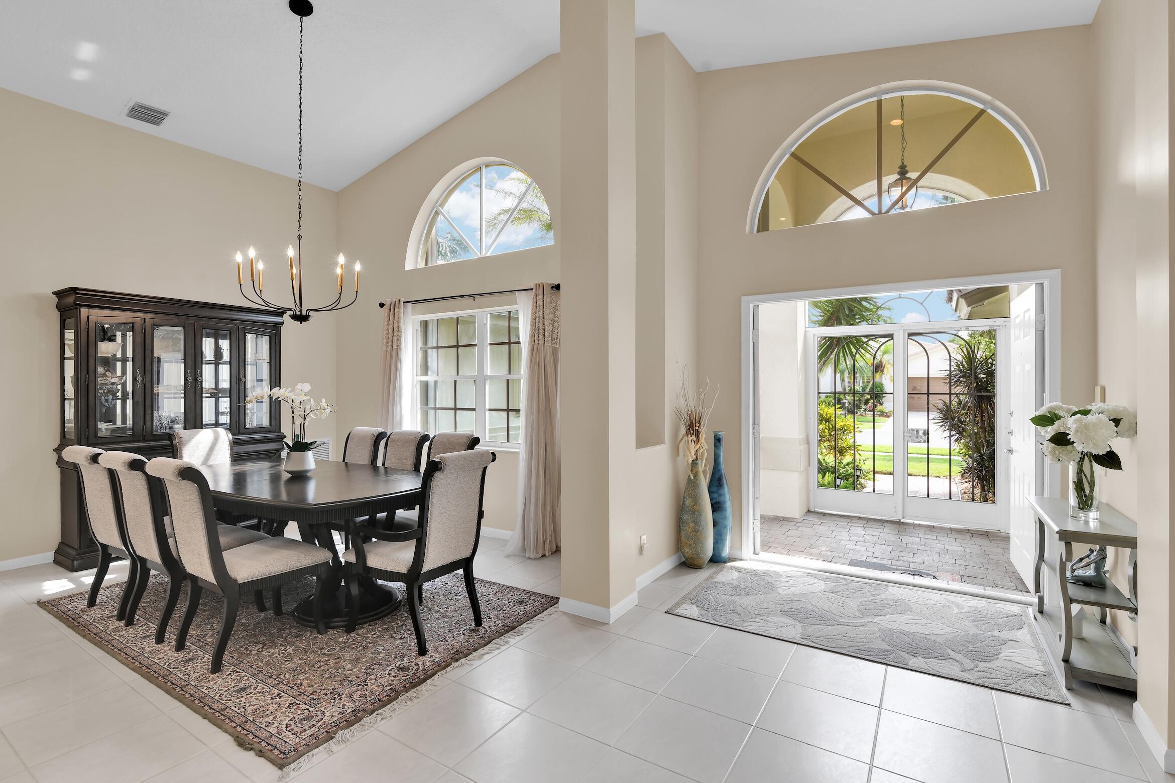 7458 Falls Road West Boynton Beach, FL 33437 - Photo 7 of 45 a dining room with furniture a chandelier and window