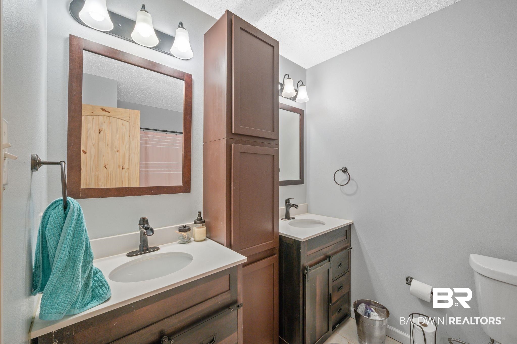 620 Southern Way Spanish Fort, AL 36527 - Photo 13 of 18 Bathroom with toilet, vanity, and a textured ceiling