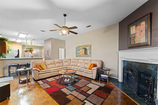 a living room with furniture a fireplace and a chandelier