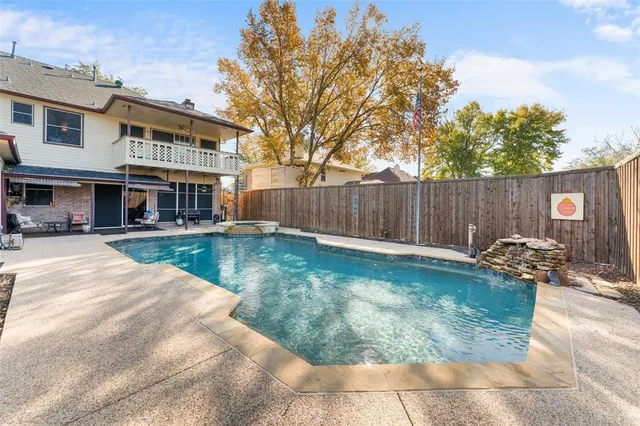 a view of swimming pool with a patio and a yard