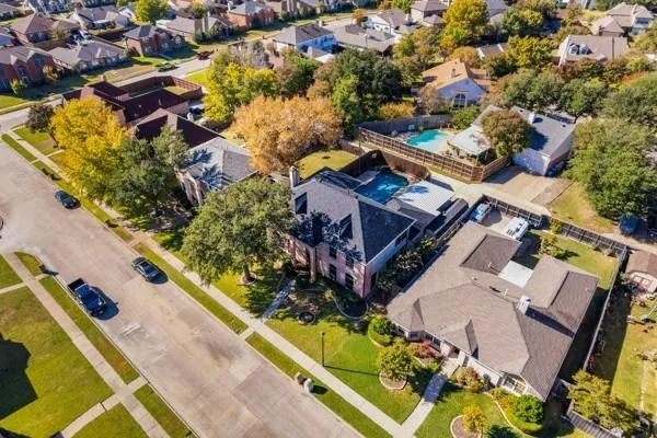 an aerial view of a residential houses with outdoor space