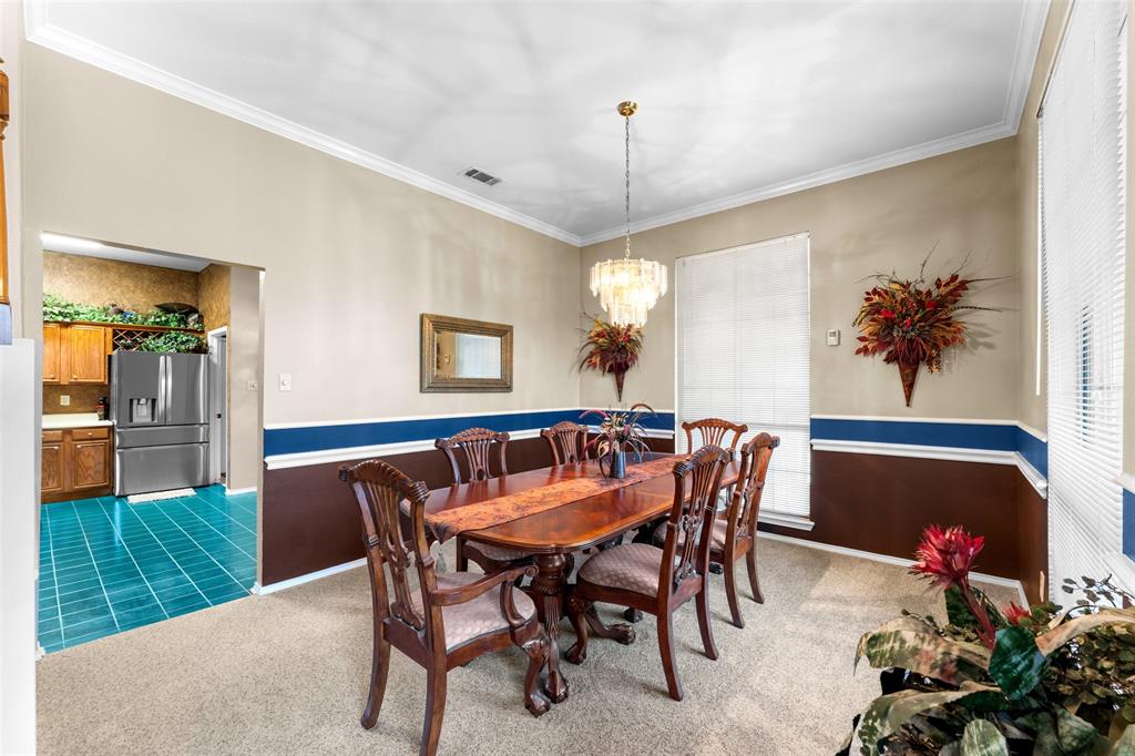 5509 Allen Lane Rowlett, TX 75088 - Photo 7 of 34 Tiled dining room with ornamental molding, carpet floors, and a chandelier