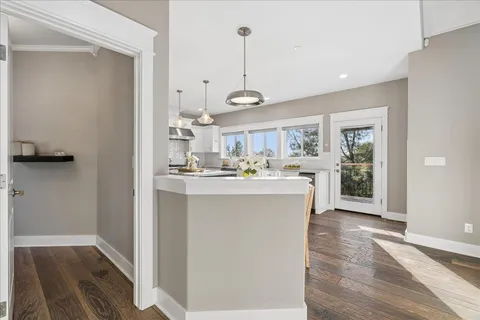 a kitchen with lots of counter space and wooden floor