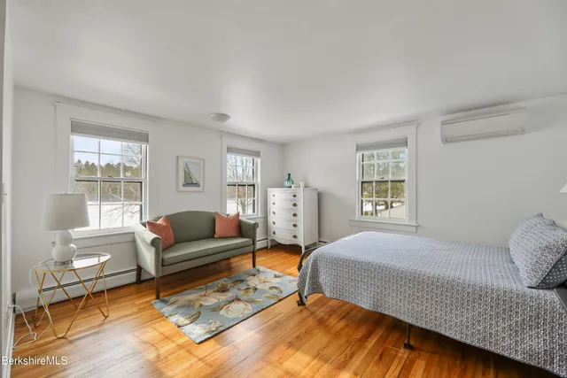 a bedroom with furniture and a window