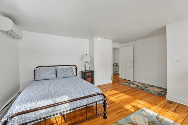 a bedroom with a bed and a night stand