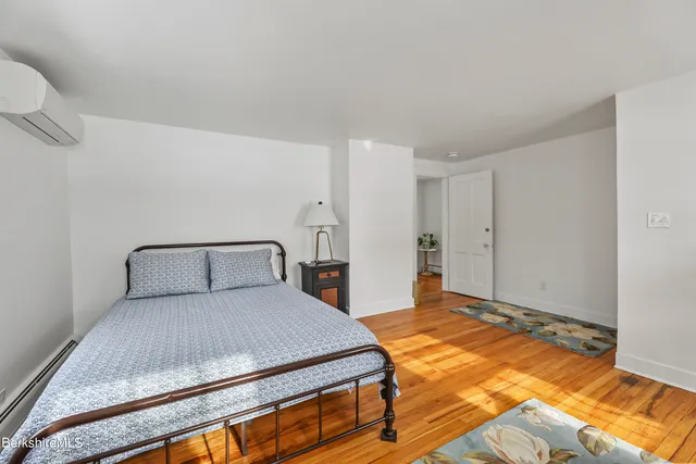 a bedroom with a bed and a night stand