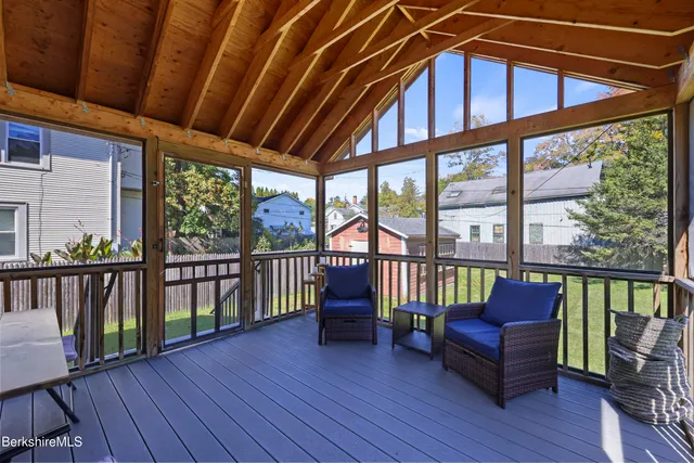 a balcony with furniture and wooden floor