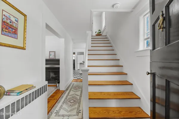 a view of entryway and hall with wooden floor