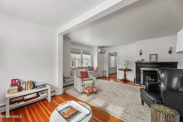 a living room with furniture a rug and a fireplace
