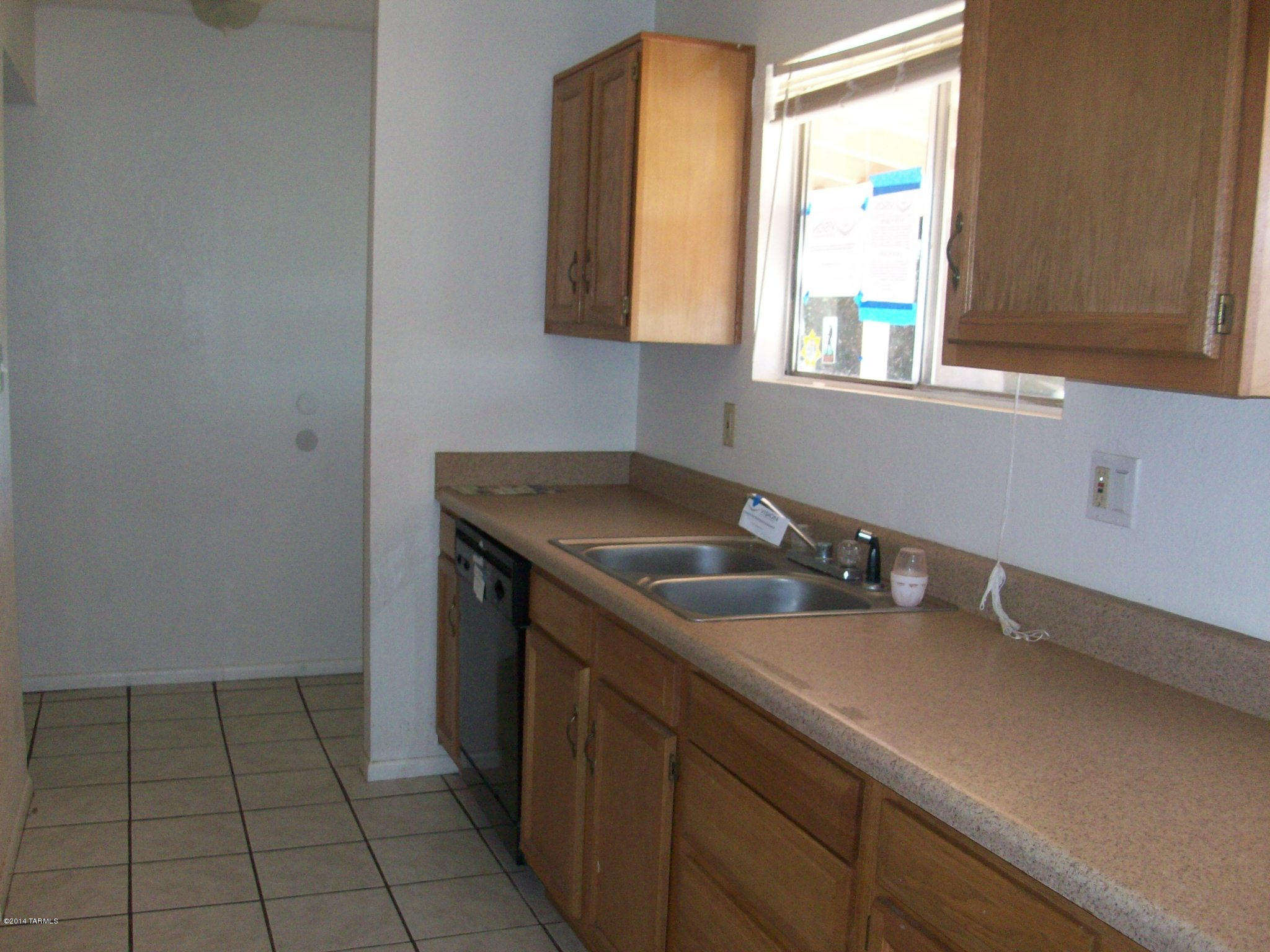 1161 Hodges Circle Rio Rico, AZ 85648 - Photo 9 of 23 a kitchen with a sink and cabinets
