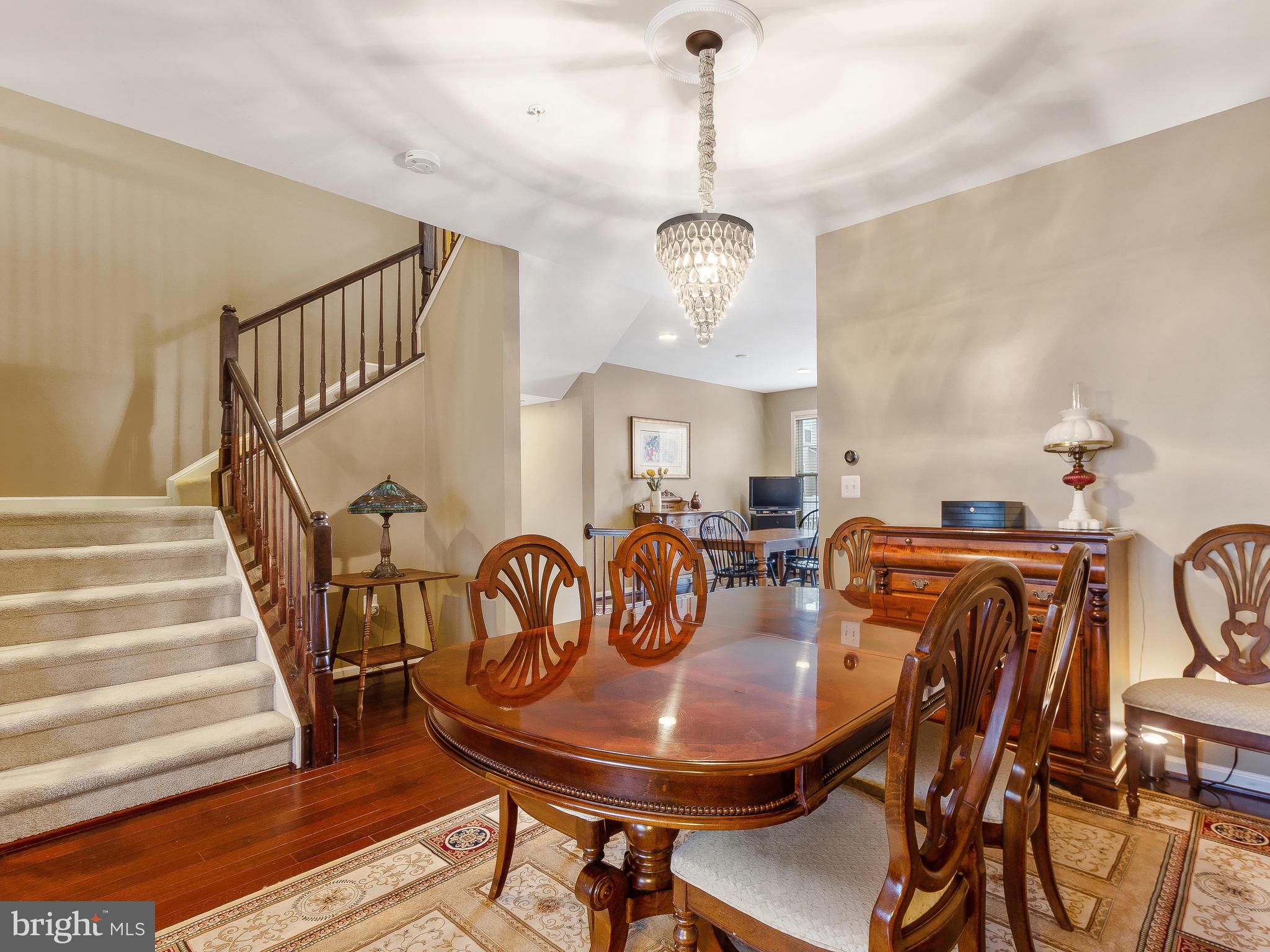 13610 Stargazer Lane Silver Spring, MD 20906 - Photo 15 of 43 a view of a dining room with furniture wooden floor and chandelier