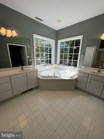 a living room with a bed furniture and a flat screen tv