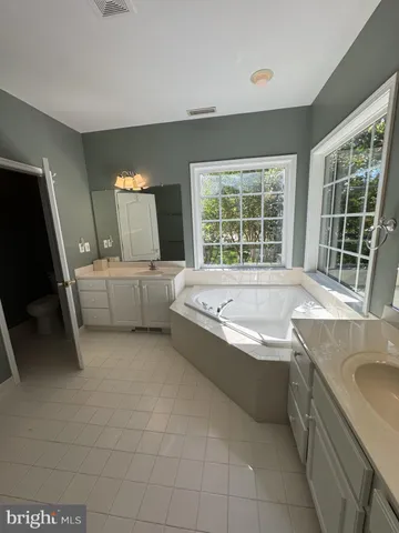 a large white kitchen with a large window