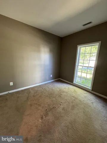 a view of an empty room and a window