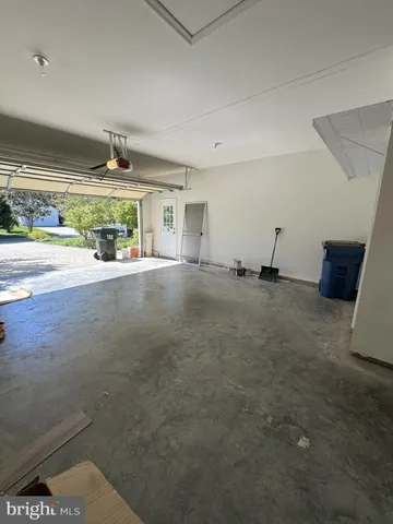 a view of swimming pool with outdoor seating and trees in the background