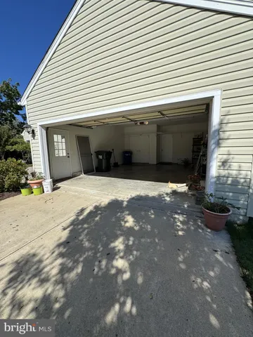 a view of a livingroom with kitchen and a window