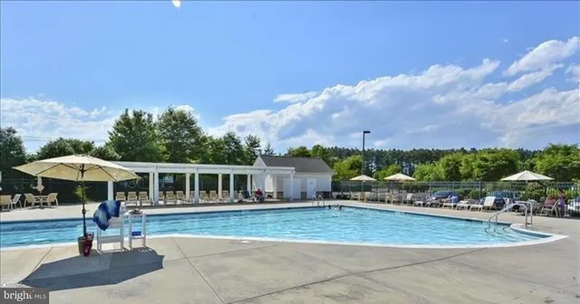 a view of swimming pool with a garden and trees
