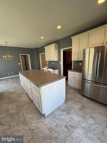 a kitchen with stainless steel appliances a refrigerator sink stove microwave and cabinets